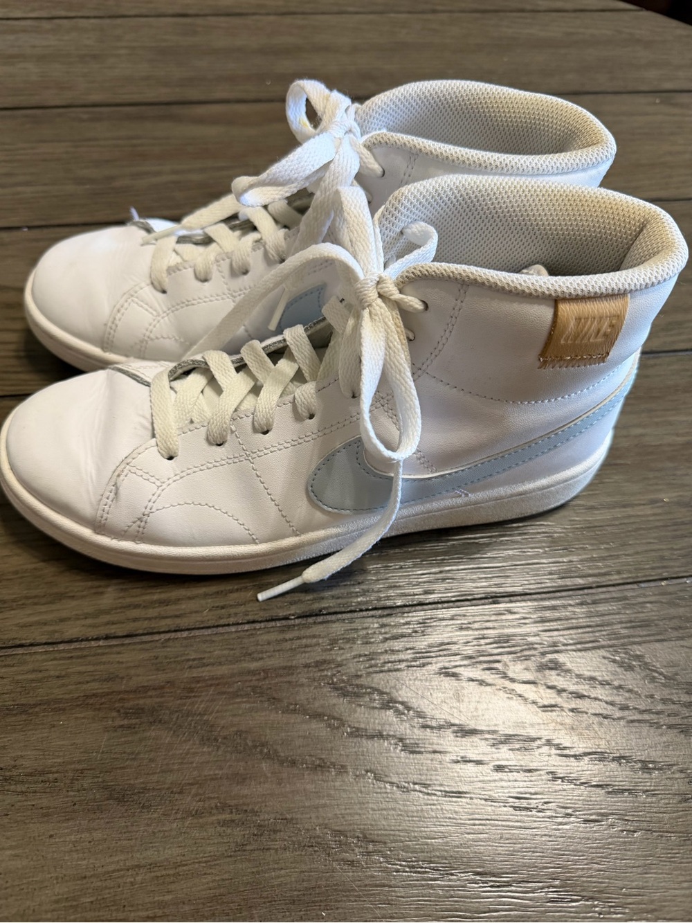 Nike White High-Top Sneakers with Light Blue Swoosh and Tan Heel Tab